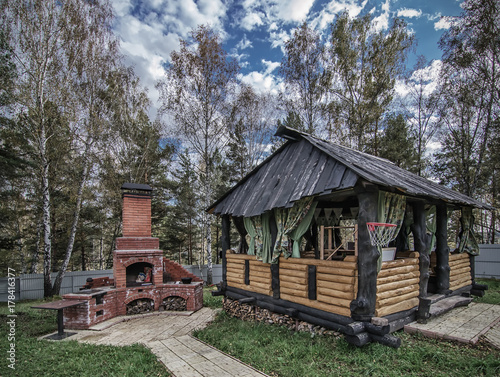 Obraz na płótnie wooden gazebo and outdoor brick oven in backyard w salonie