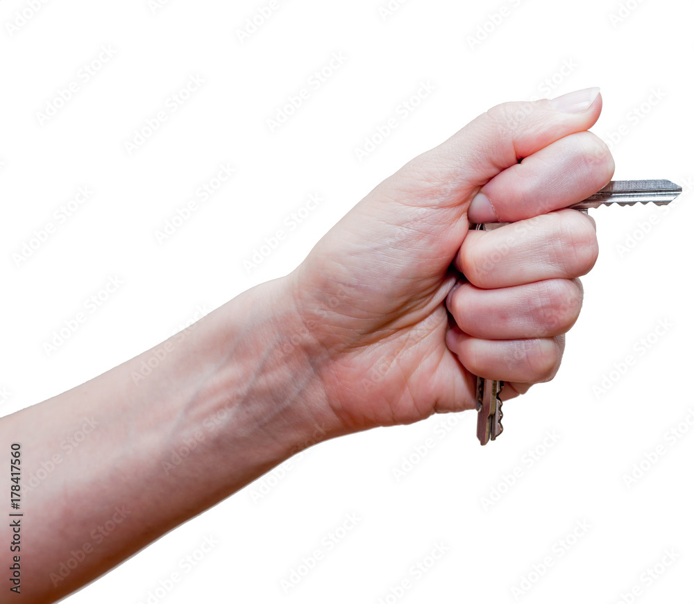 Female fist with clipped keys. Using of improvised stuff (door keys) for protection. The blow with such fist will cause more damage. Self-defense concept. Isolated on white background. Female fist with clipped keys. Using of improvised stuff (door keys) for protection. The blow with such fist will cause more damage. Self-defense concept. Isolated on white background.