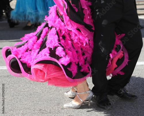 woman with fuchsia dress while dancing with a man on the road photo