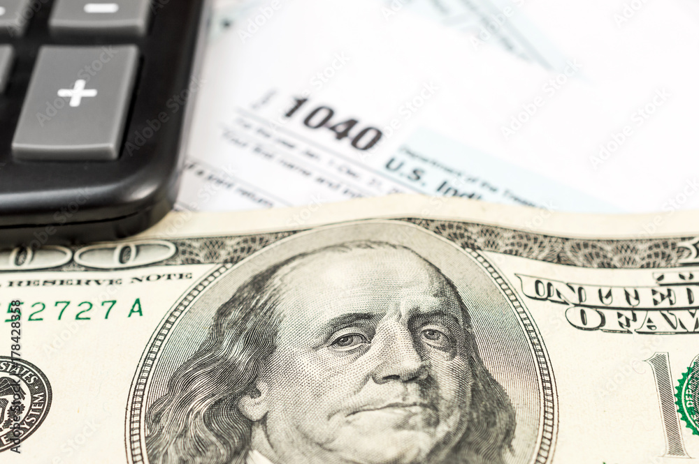 Tax form with calculator and money. Close up. Business concept. Tax form with calculator and money. Close up. Business concept.