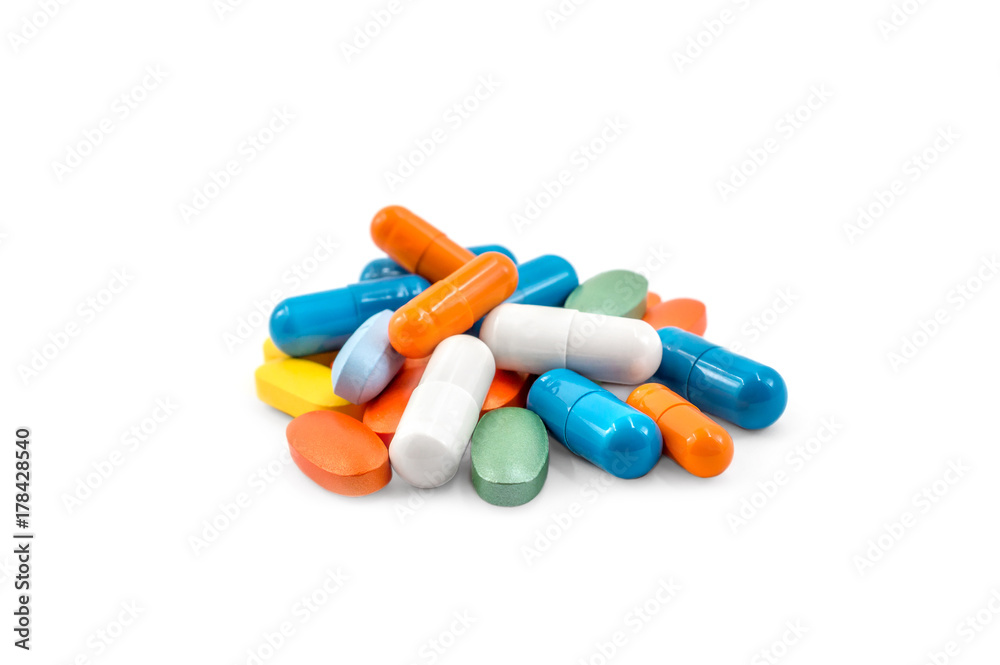 Heap of different colorful pills on a white. Heap of different colorful pills on a white.