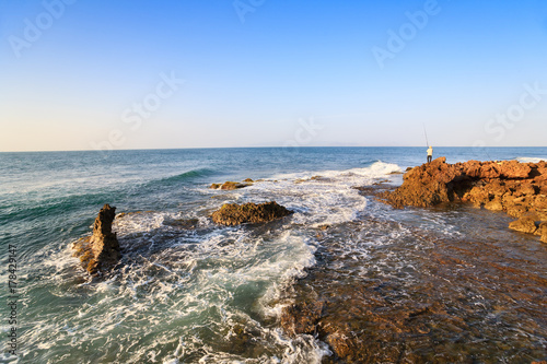 Fisherman is fishing at My Hiep beach in early morning, Ninh Thuan, Vietnam. Ninh Thuan is famous for beautiful landscapes, majestic Cham towers and unique Cham culture.