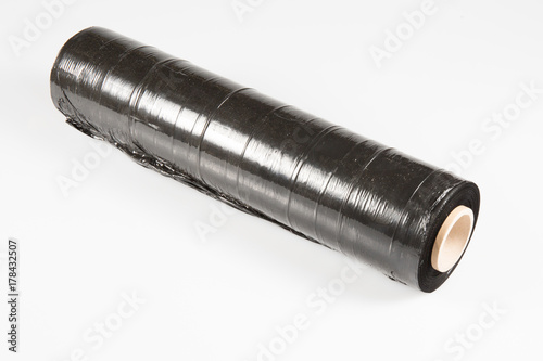 Roll of a packing film of black color on white background photo