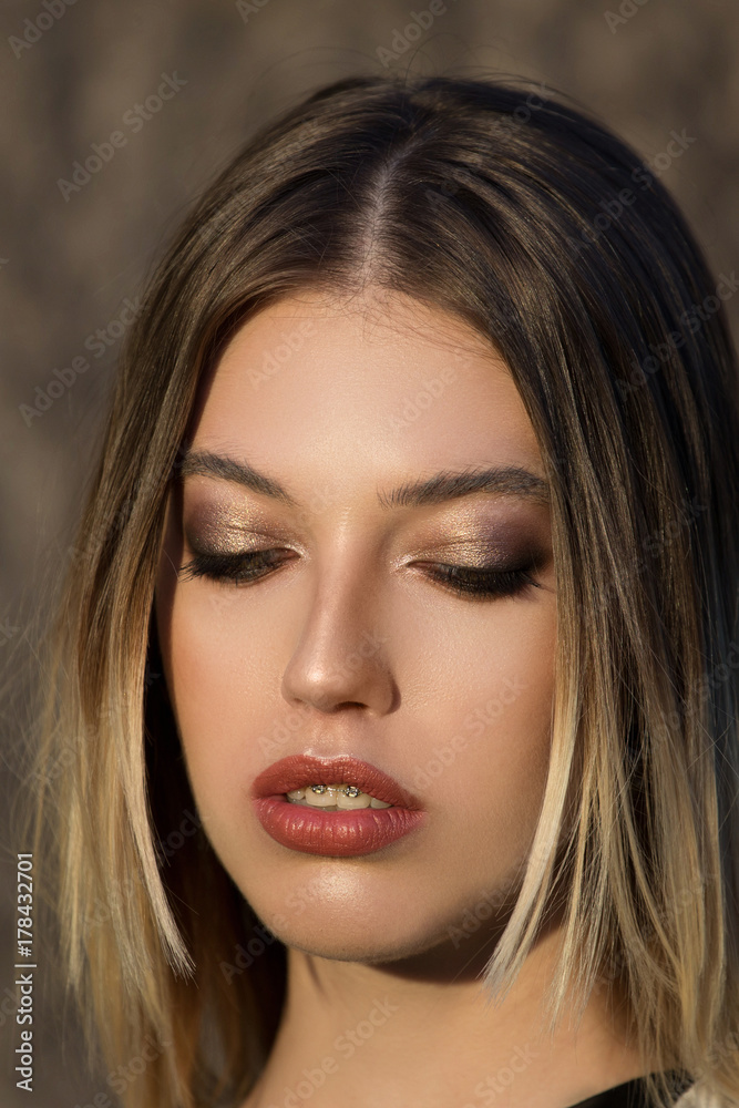 Portrait of a beautiful woman posing outdoors. Portrait of a beautiful woman posing outdoors.