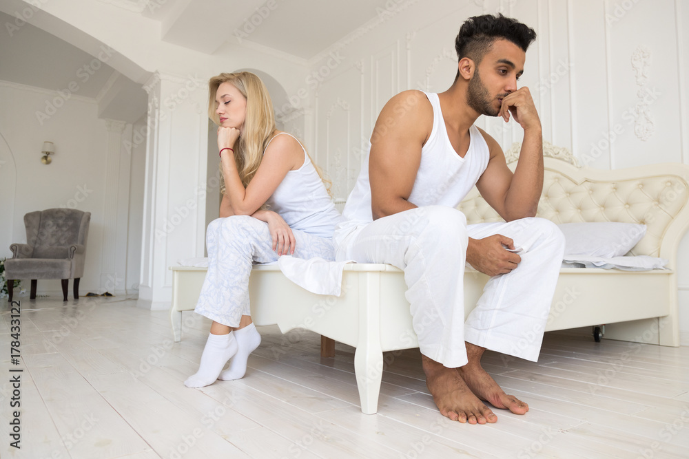 Young Couple Sitting Separate On Bed, Having Conflict Relationships Problem, Sad Negative Emotions Hispanic Man And Woman Lovers Argue In Bedroom Young Couple Sitting Separate On Bed, Having Conflict Relationships Problem, Sad Negative Emotions Hispanic Man And Woman Lovers Argue In Bedroom
