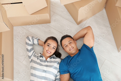 Happy young couple lying on...