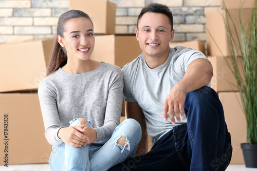 Happy young couple sitting ...