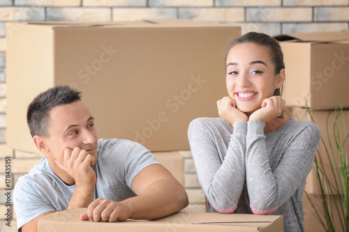 Happy young couple with mov...
