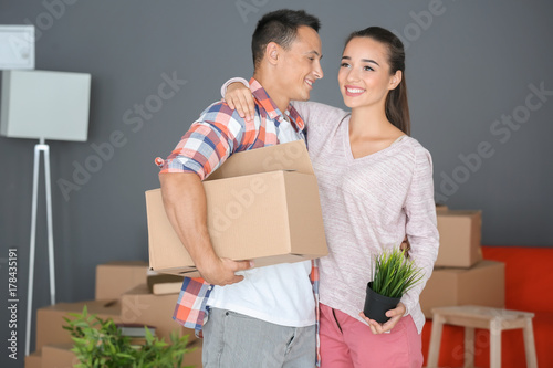 Happy young couple with mov...