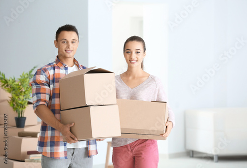 Happy young couple with mov...