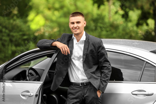Handsome young businessman near car in park © Africa Studio