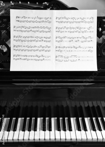 Music notes on black piano