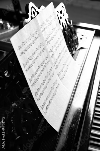 Music notes on black piano