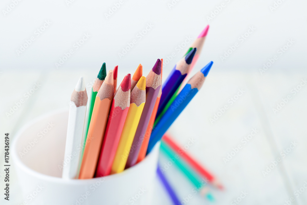 Color pencils in cup on light background, closeup Color pencils in cup on light background, closeup