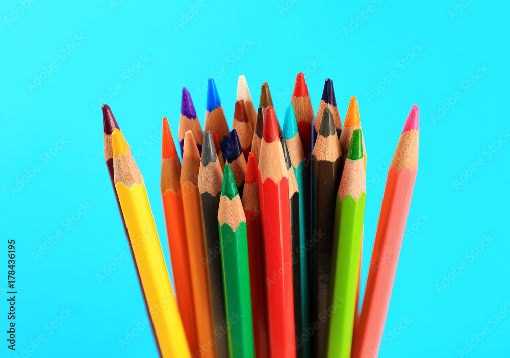 Fototapeta Color pencils on blue background, closeup