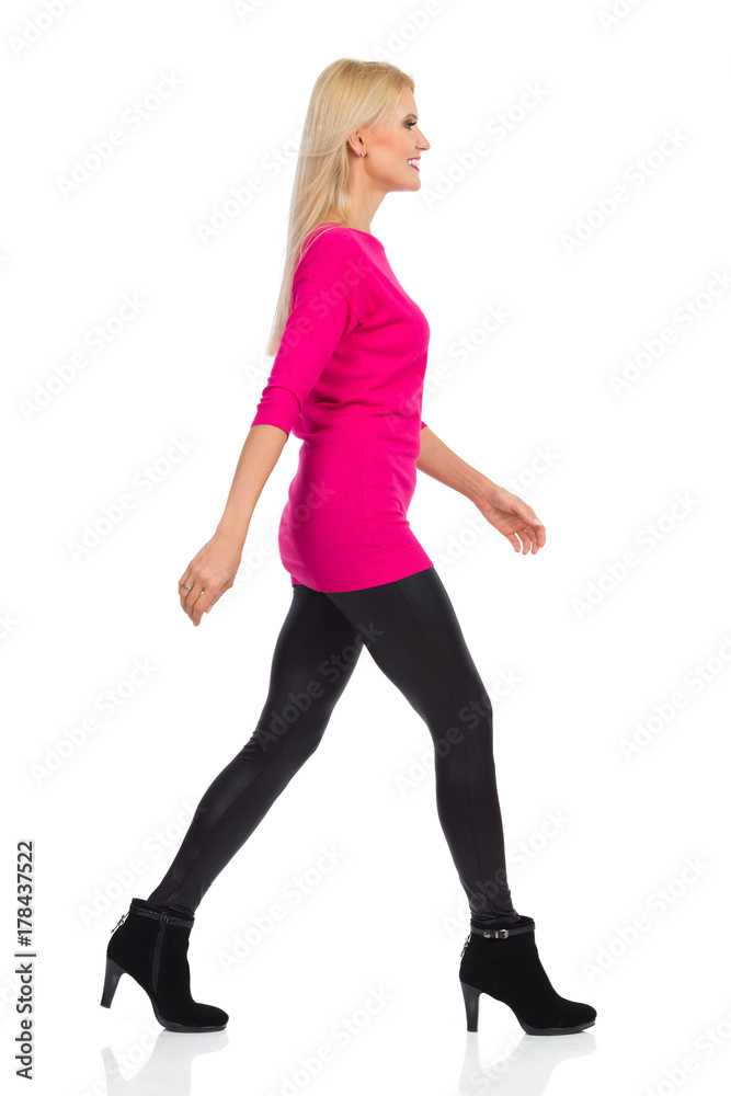 Smiling Blond Woman Is Walking. Side View. Isolated On White Smiling Blond Woman Is Walking. Side View. Isolated On White