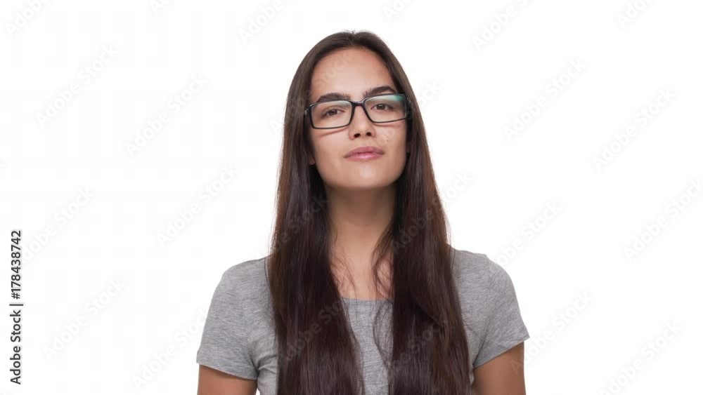 portrait of pretty young woman with long dark hair wearing glasses confidently, looking at camera with smile isolated over white background closeup. Concept of emotions portrait of pretty young woman with long dark hair wearing glasses confidently, looking at camera with smile isolated over white background closeup. Concept of emotions