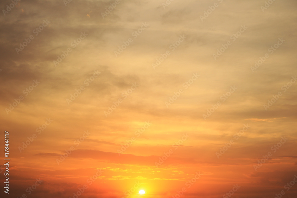 Evening sky and orange sun at sunset, calm cloudscape