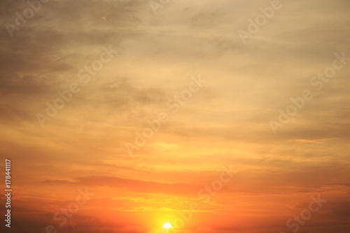 Fototapeta Naklejka Na Ścianę i Meble -  Evening sky and orange sun at sunset, calm cloudscape