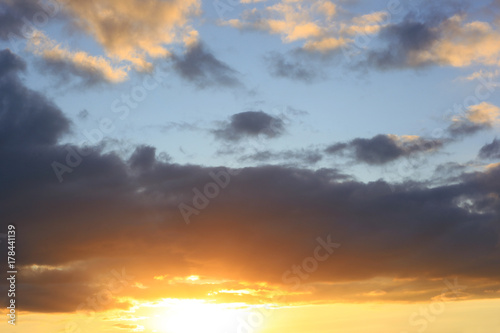Cloudy sky and sun at sunset, dramatic cloudscape