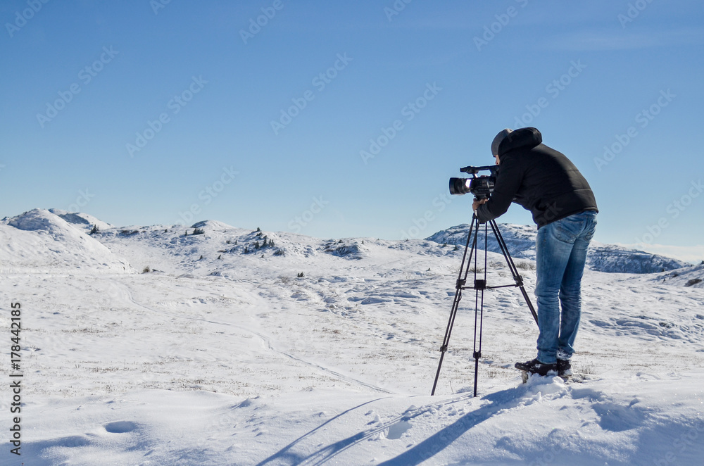Cameraman taking video at the top of the mountain
