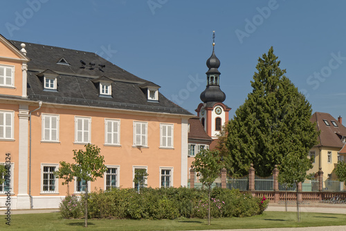 Schwetzingen, Germany - a palace courtyard with a church tower in the background