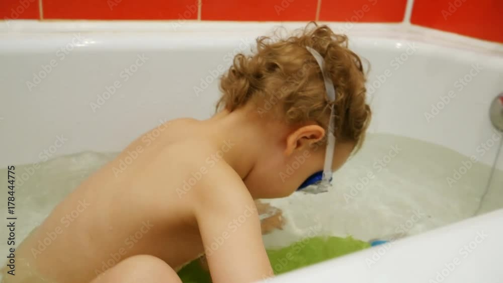 Baby in Bathtub plays and dives Baby in Bathtub plays and dives