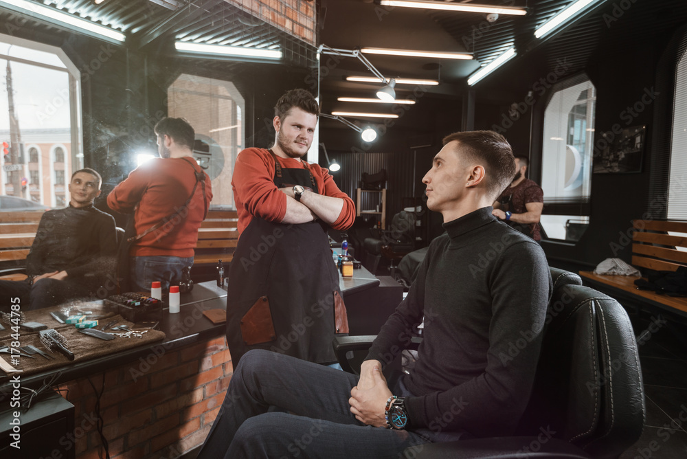 haircut is ready/ Barber evaluates the customer's haircut in the armchair haircut is ready/ Barber evaluates the customer's haircut in the armchair