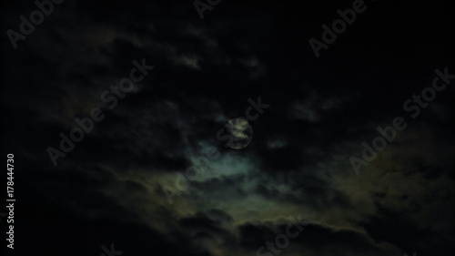 New Moon and Clouds in the Pitchblack Sky
