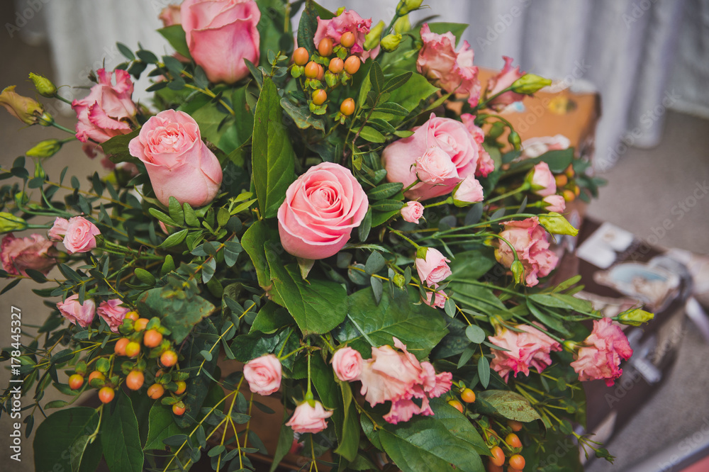 A huge bouquet of roses and various greenery. 8579