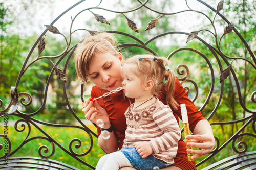 mother and daughter blow bubbles photo