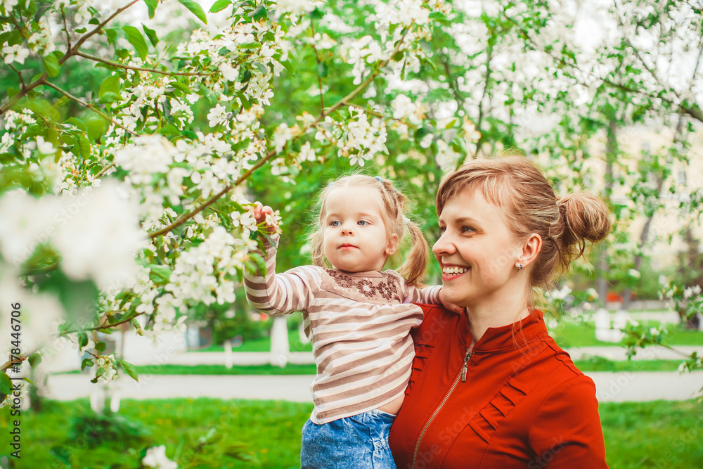 Fototapeta premium mother and daughter in flower garden