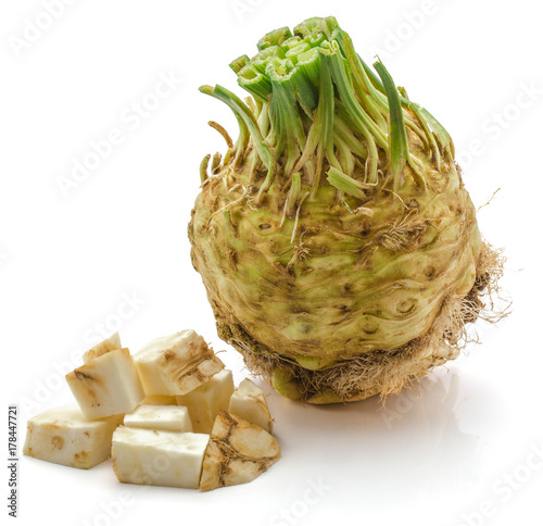 One whole bulb of celery root and sliced pieces isolated on white background photo