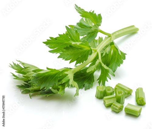 Sliced fresh celery pieces and leaves isolated on white background photo