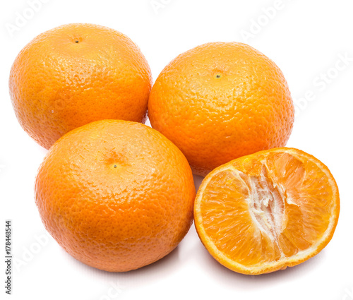 Three whole Clementines and one half isolated on white background
