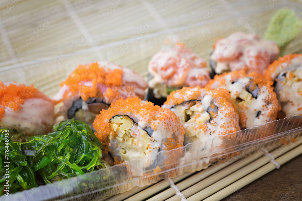 close up of sushi rolls with salmon, calf caviar and cheese. Japanese food.