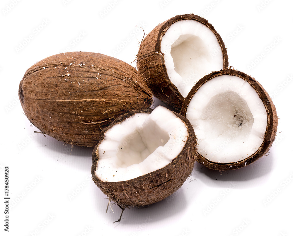 One whole coconut and three halves isolated on white background One whole coconut and three halves isolated on white background