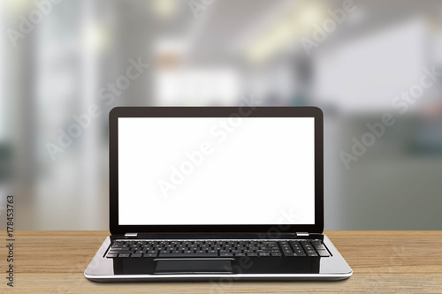 Laptop with blank white screen on blurred modern office background, business concept © shark749