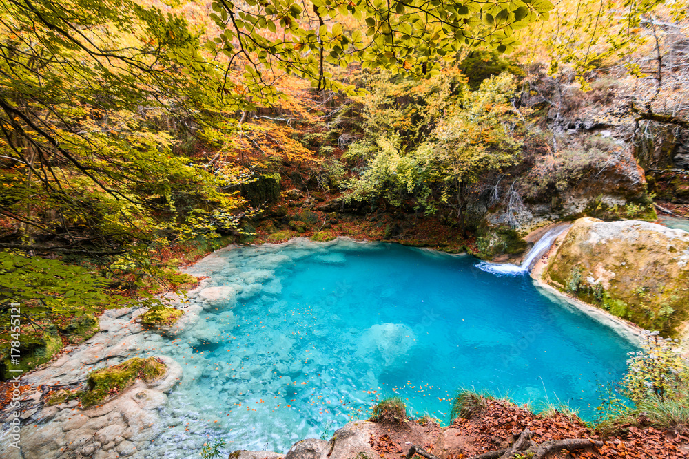 Fototapeta premium colorful autumn landscape at urederra source, Spain