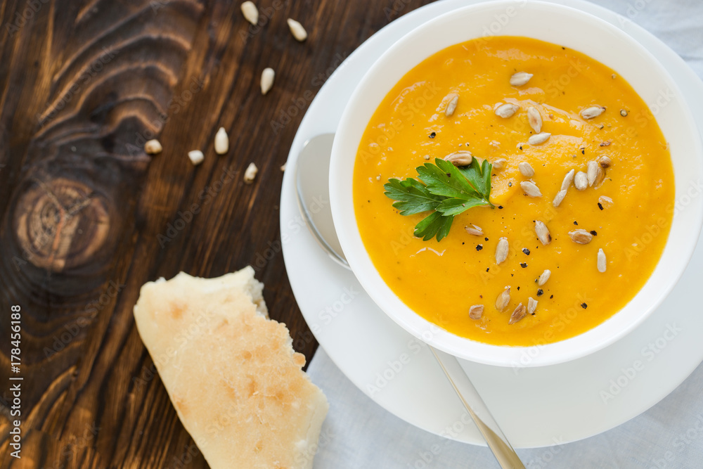 Dinner with carrot soup-puree served in white bowl Dinner with carrot soup-puree served in white bowl