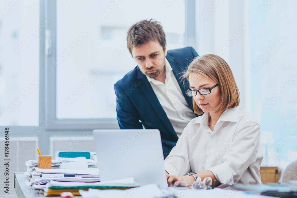 Manager monitoring work of employee Stock Photo | Adobe Stock