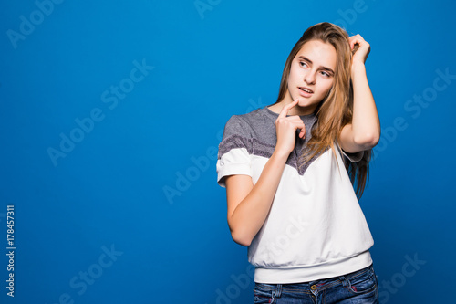 Portrait of beautiful young woman smiling against blue background