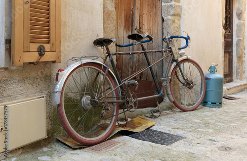 Bicycle on the old street in the village Coaraze, France photo