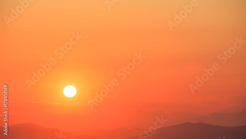 Fototapeta Naklejka Na Ścianę i Meble -  Beautiful sunset on sky over mountains background. The sun is on the leftt side.