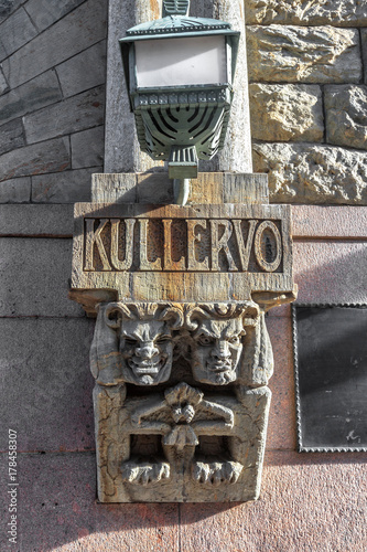 Two stone trolls embedded in a Helsinki building. photo