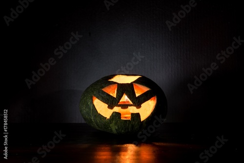 Halloween pumpkin with scary face and candle on black background, Jack O'Lantern, happy halloween