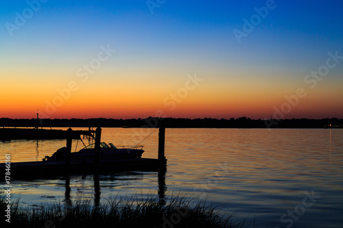 Dock  boat and marshes at sunset and blue hour off New Jersey inlet.