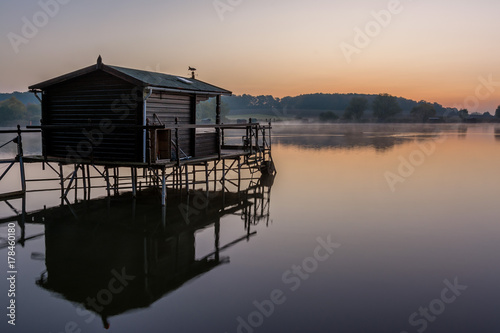 French countryside - Lorraine. A small lake with fisherman's hut at sunrise. © PhotoGranary