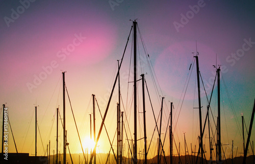 Masts of yachts with sunset light