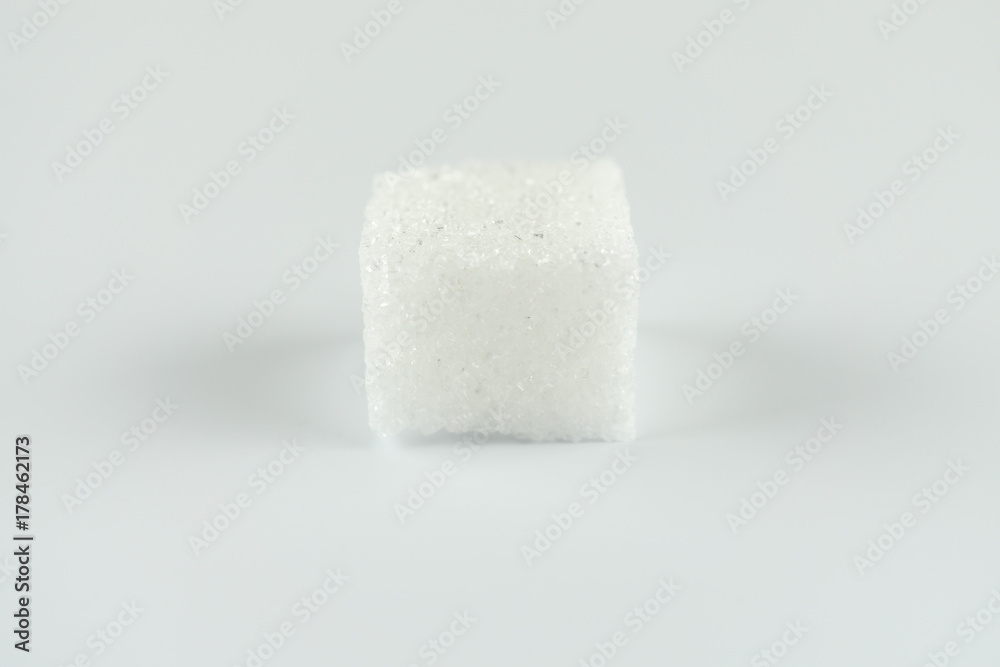 One sugar cube on white background One sugar cube on white background